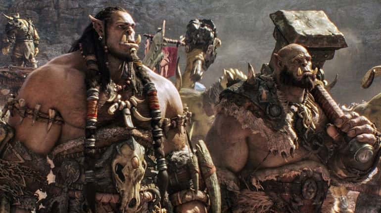 Durotan (voiced by Toby Kebbell), left, and Orgrim (voiced by...