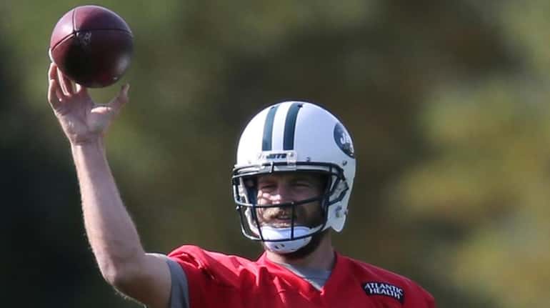 New York Jets quarterback Ryan Fitzpatrick throws during practice in...