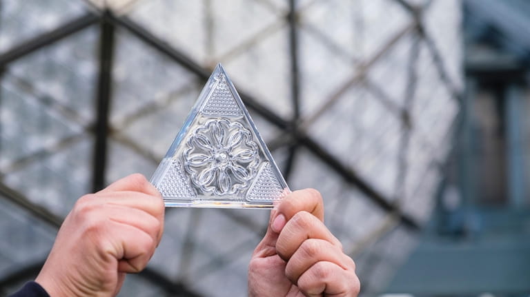 Waterford Crystal triangles are installed on the ball atop One...