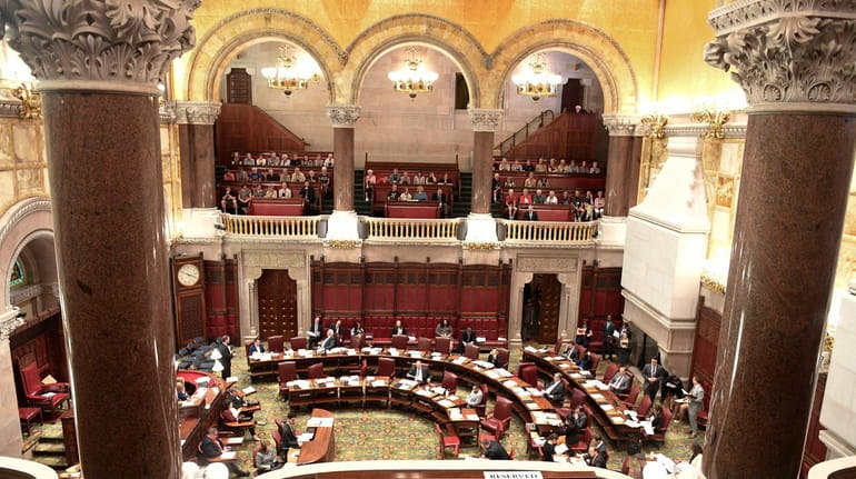 Members of the New York State Senate work on passing...