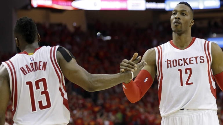 Houston Rockets guard James Harden (13) and center Dwight Howard...