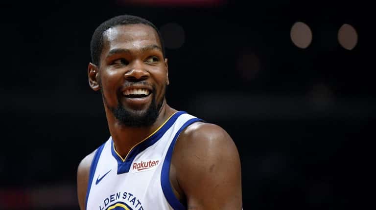 Kevin Durant #35 of the Golden State Warriors smiles at...