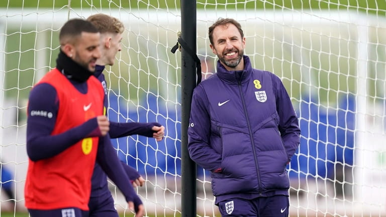 England manager Gareth Southgate, right, smiles as he leads a...