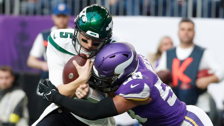 Jets quarterback Mike White is tackled by Vikings linebacker Jordan Hicks during...