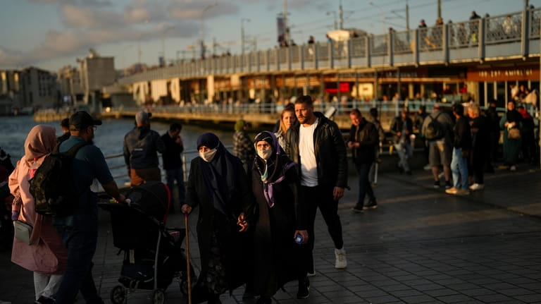 People walk near Galata bridge in Istanbul, Turkey, Tuesday, May...
