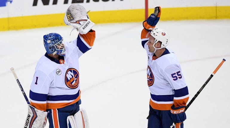 Islanders goaltender Thomas Greiss celebrates with defenseman Johnny Boychuk after...
