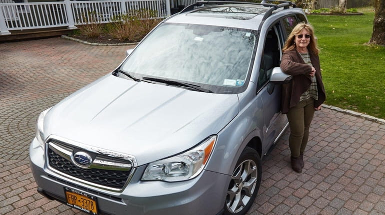 Dawn Oates with her Subaru Forester at her home in...