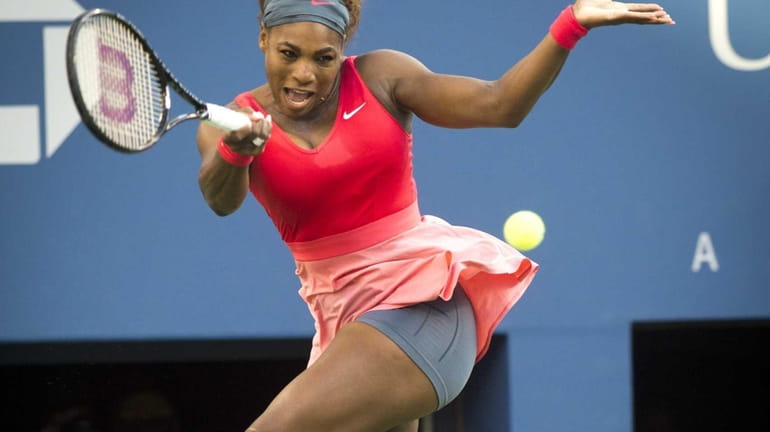 Serena Williams hits a running forehand against Li Na during...