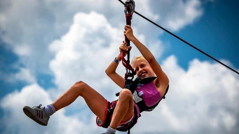 Long Beach resident Michaela Murphy, 10, enjoys the zipline at WildPlay...