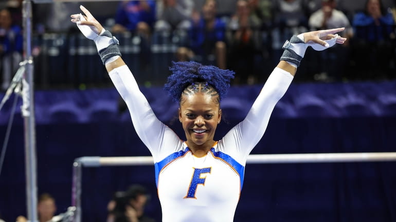 FILE - Florida's Trinity Thomas competes on the uneven bars...