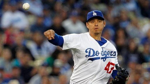 Los Angeles Dodgers third baseman Luis Cruz throws out Atlanta...