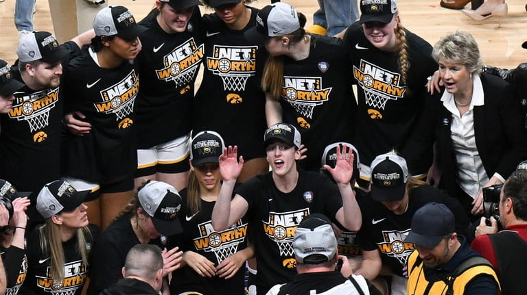 Iowa guard Caitlin Clark, center, poses with teammates for a...
