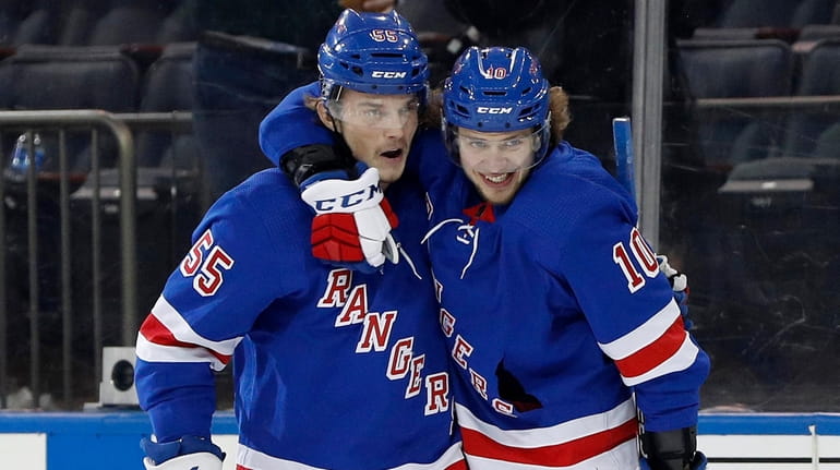 Artemi Panarin of the Rangers, right, celebrates his first goal of...