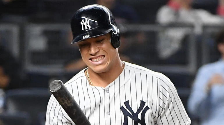 Yankees rightfielder Aaron Judge reacts after striking out against the...