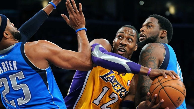 The Los Angeles Lakers' Dwight Howard (12) tries to get...