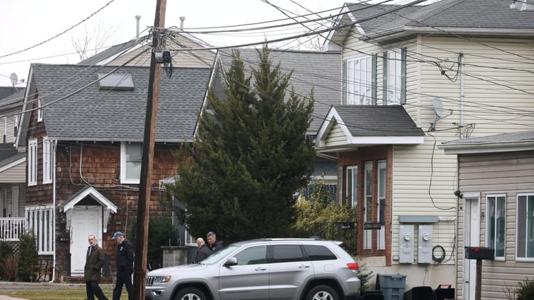 Police search for evidence at a home on Railroad Avenue in...