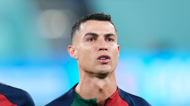 Portugal's Cristiano Ronaldo reacts while listening to the Portugal's national...