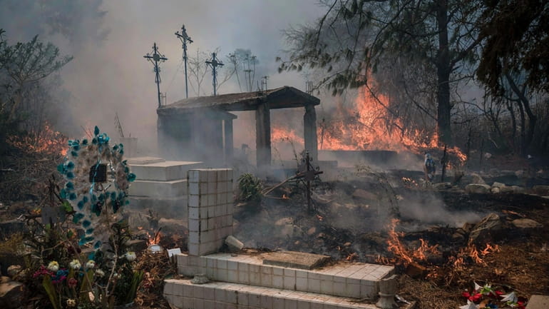 Wildfires burn parts of a cemetery in Nogales, Mexico, Monday,...