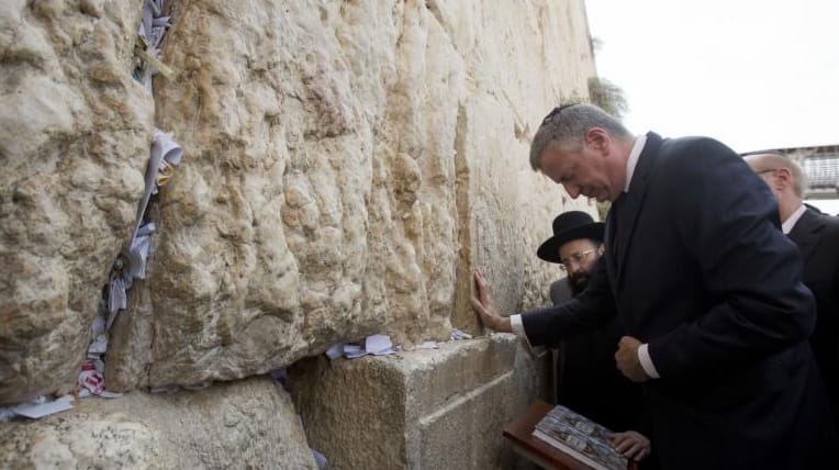 New York City’s mayor, Bill De Blasio, touches the stones...