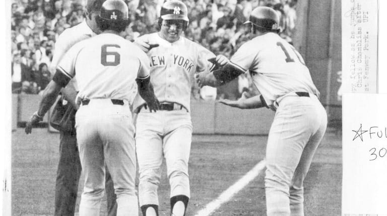  Bucky Dent is a happy fellow as he jumps on...