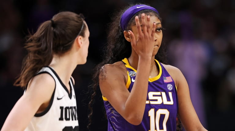 LSU's Angel Reese reacts toward Iowa's Caitlin Clark in the national...