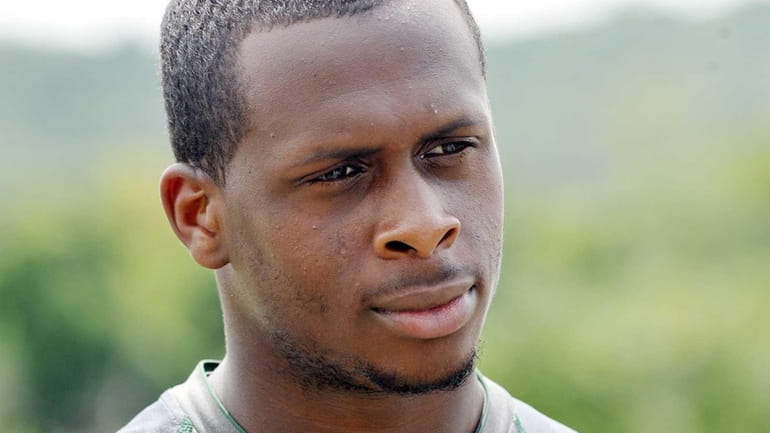 Jets quarterback Geno Smith talks with reporters during training camp....