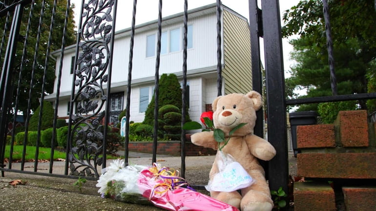 Flowers and a bear sat outside the gate, where State...