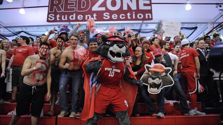 The Stony Brook mascot Wolfie and fans cheer before action...