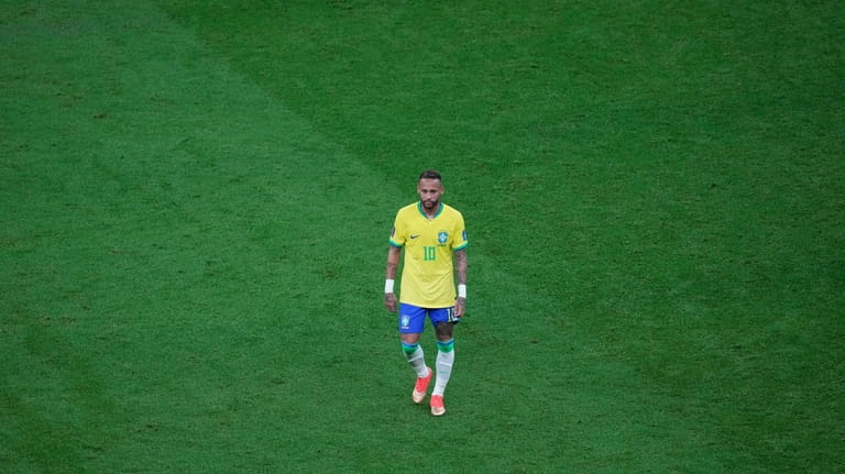 Brazil's Neymar walks on the pitch during the World Cup...