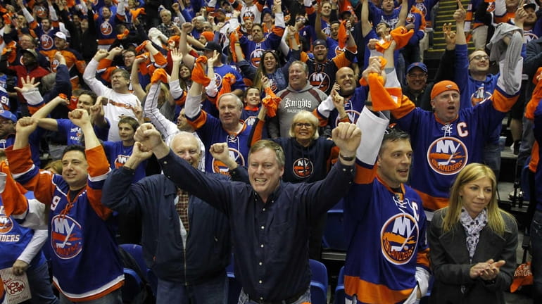 New York Islanders fans celebrate after a third-period goal against...