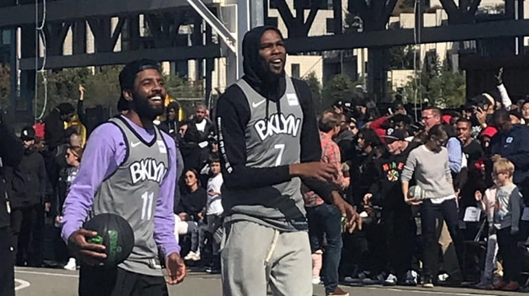 Nets stars Kyrie Irving and Kevin Durant appear at an...