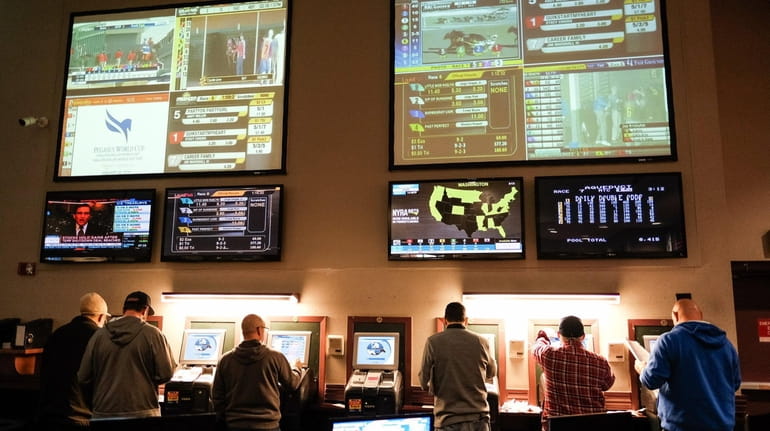 Patrons bet on horse races at The Racing Forum, operated...