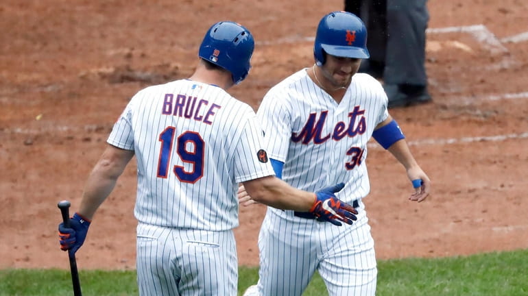 Mets rightfielder Jay Bruce greets leftfielder Michael Conforto at home after Conforto...
