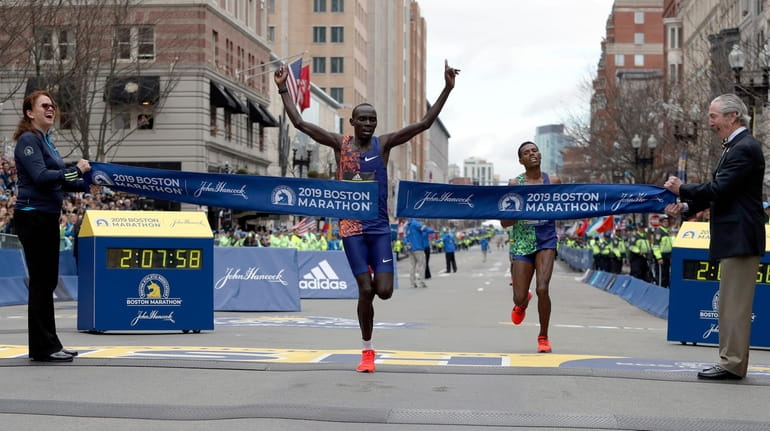 Lawrence Cherono breaks the tape to win the 123rd Boston Marathon...
