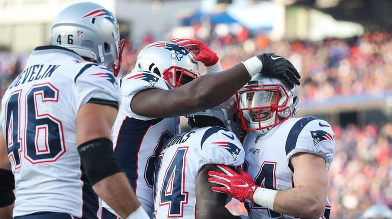 Rex Burkhead of the Patriots celebrates with teammates after scoring...