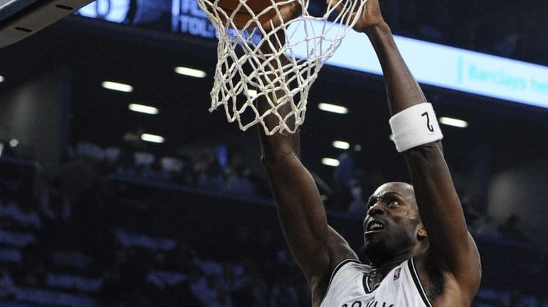 Nets forward Kevin Garnett dunks against the Toronto Raptors in...