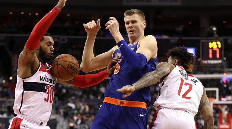 Kristaps Porzingis of the Knicks loses control of the ball...