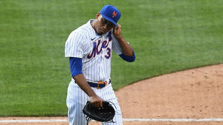 Mets relief pitcher Edwin Diaz walks to the dugout after...