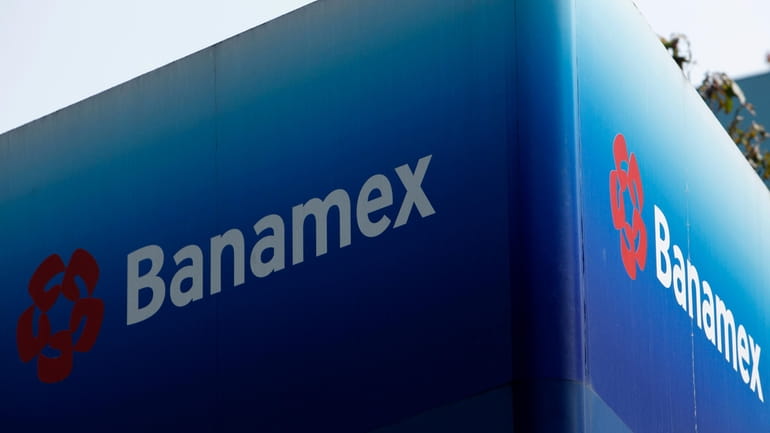 A Banamex bank sign sits front of the bank's headquarters...