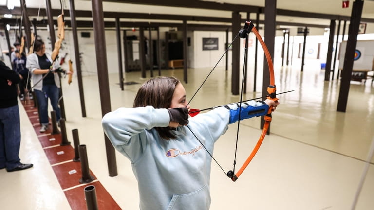 Savanna Jeffery, 10, of Mastic, shoots an arrow during youth...