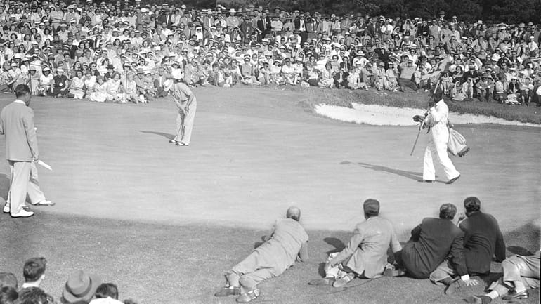 Sam Snead sinks a 20-foot putt on the 18th green...