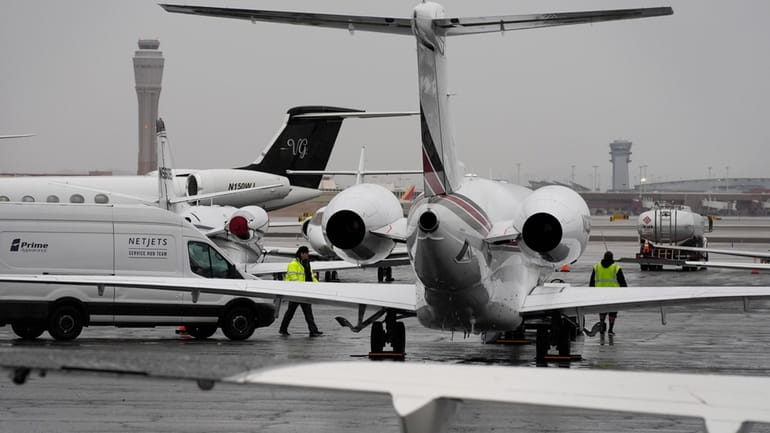 Planes are parked at a private jet terminal at Harry...