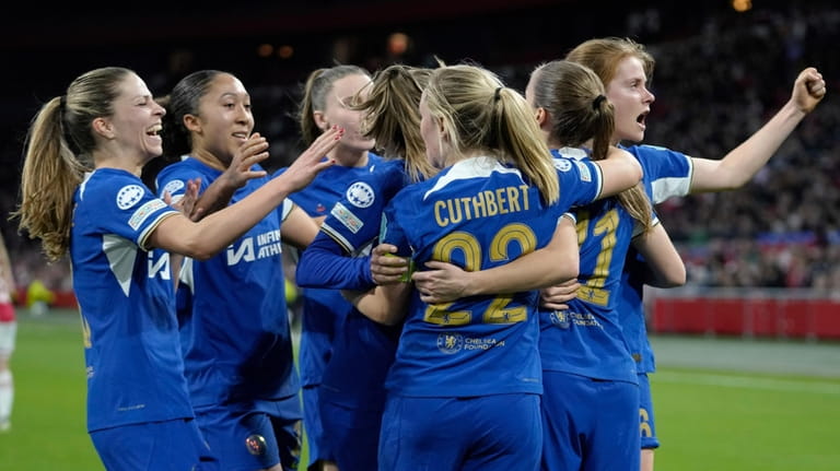 Chelsea's Sjoeke Nuksen, right, celebrates with teammates after scoring her...