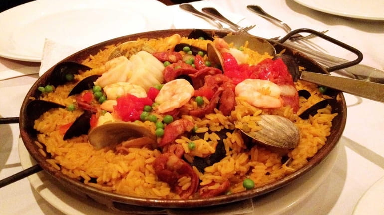 Paella Valenciana is one of the specialties at Sangria 71,...