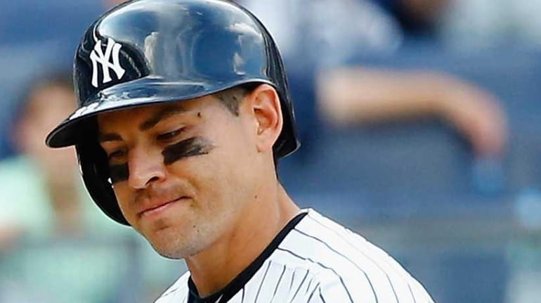 Jacoby Ellsbury of the New York Yankees reacts after striking...