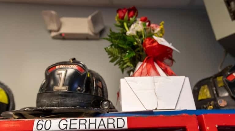 Flowers left next to Jesse Gerhard's helmet at the firehouse in Islip where...