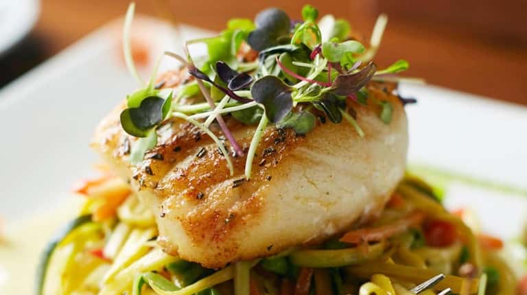 Grilled Chilean sea bass with caper berries, lemon sauce and...