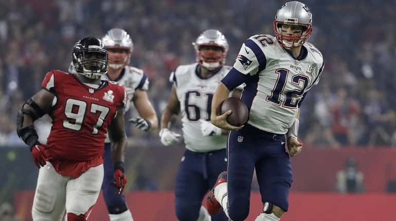 New England Patriots' Tom Brady runs against the Atlanta Falcons...