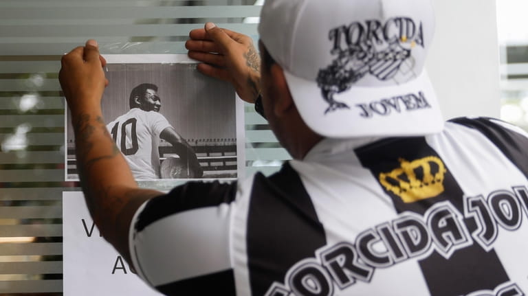 A Santos soccer team supporter posts a photo of former...