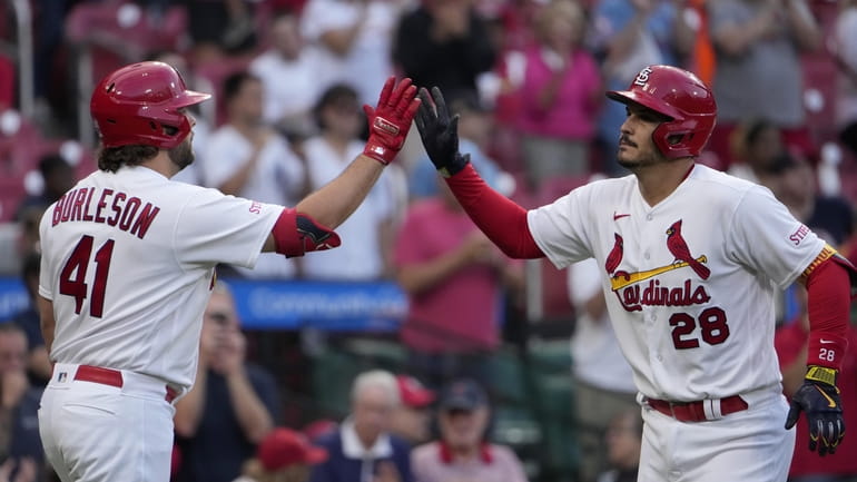 St. Louis Cardinals' Nolan Arenado (28) is congratulated by teammate...